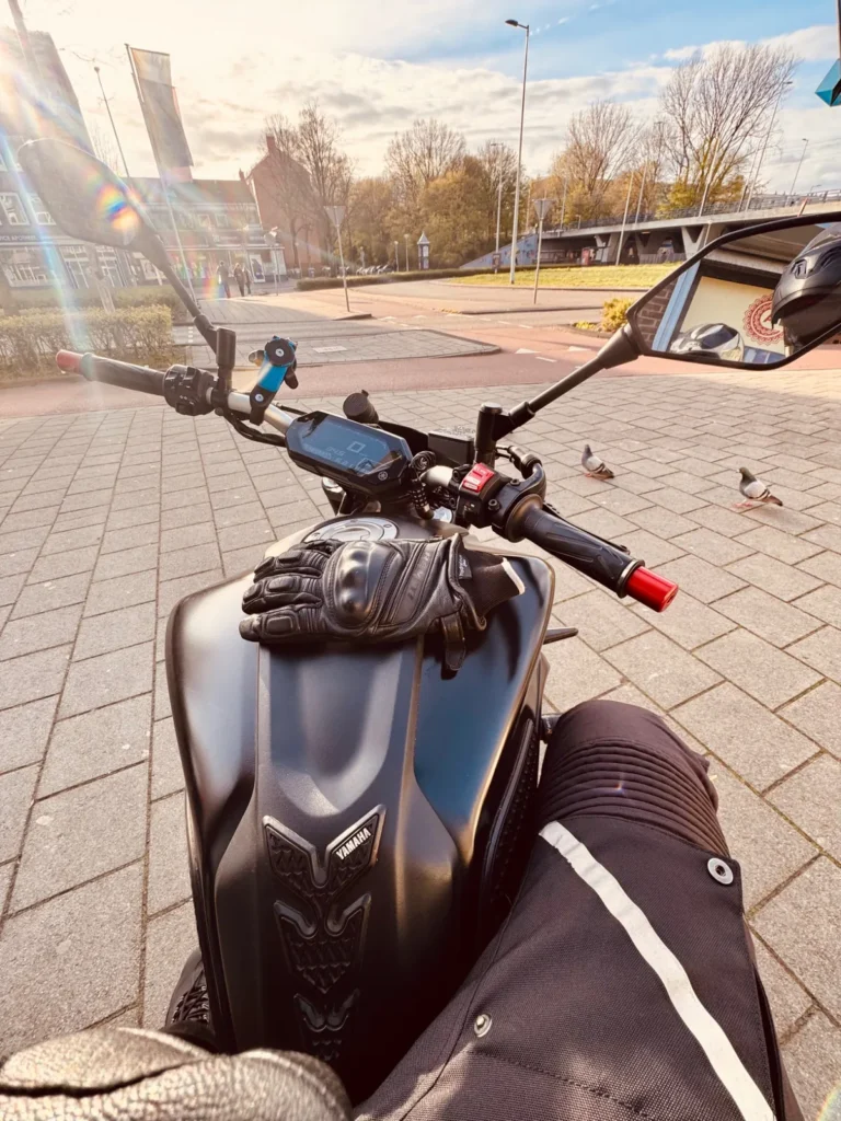 Yamaha MT-07 rider POV at a sunny Amsterdam street with gloves on the tank