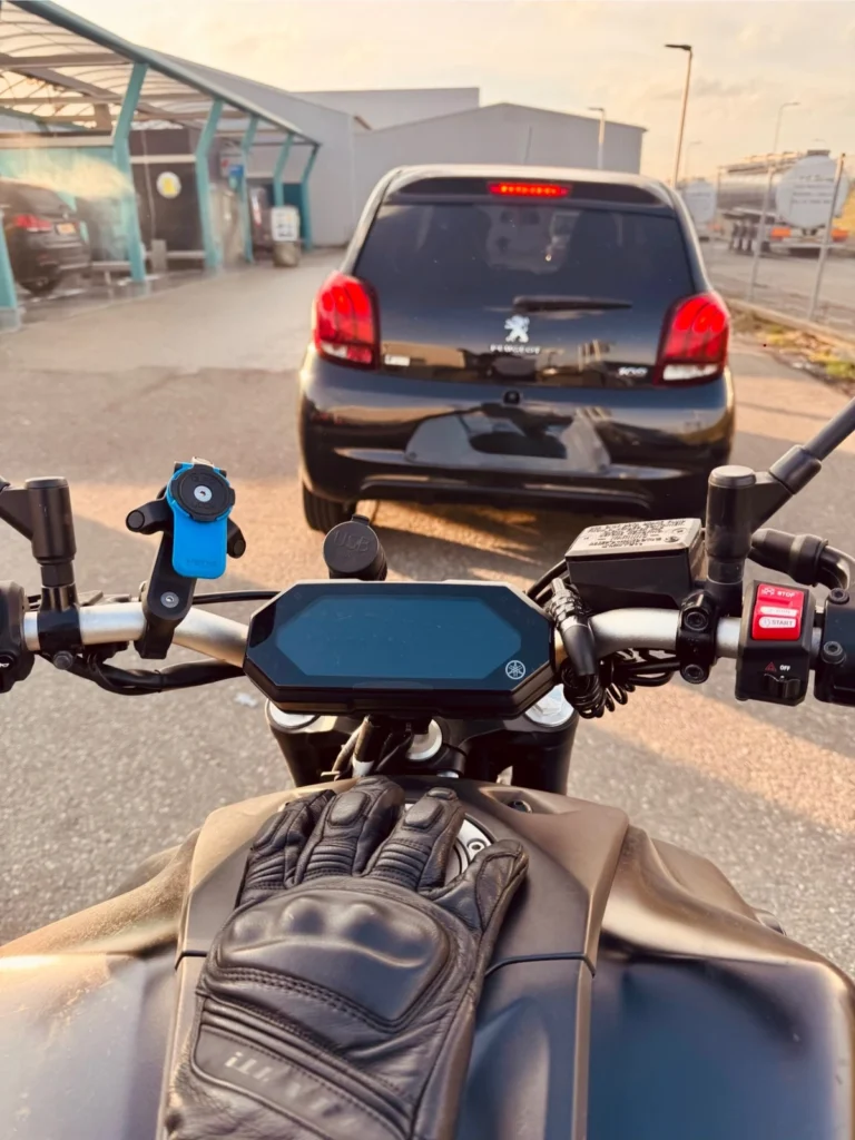 Rider POV on a Yamaha MT-07 following a car, showing why riders should avoid target fixation
