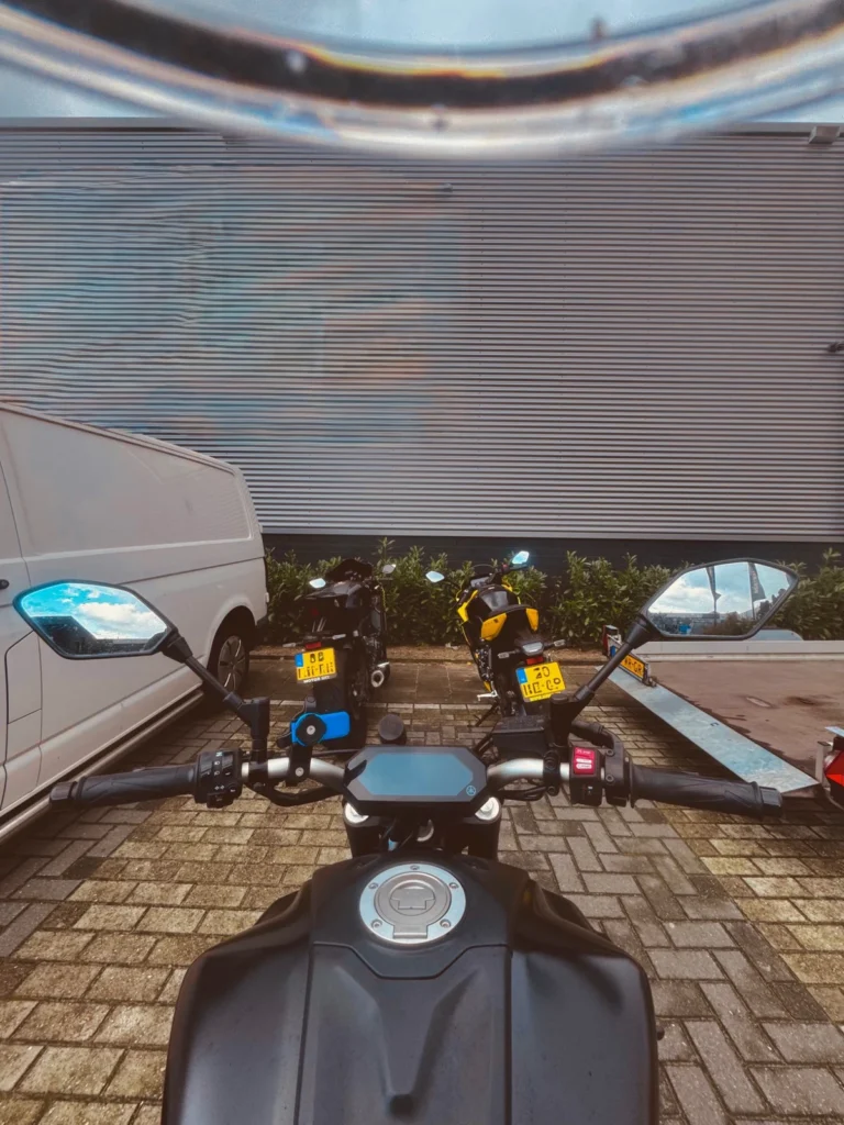 Rider POV from a Yamaha MT-07 looking at parked motorcycles and mirrors