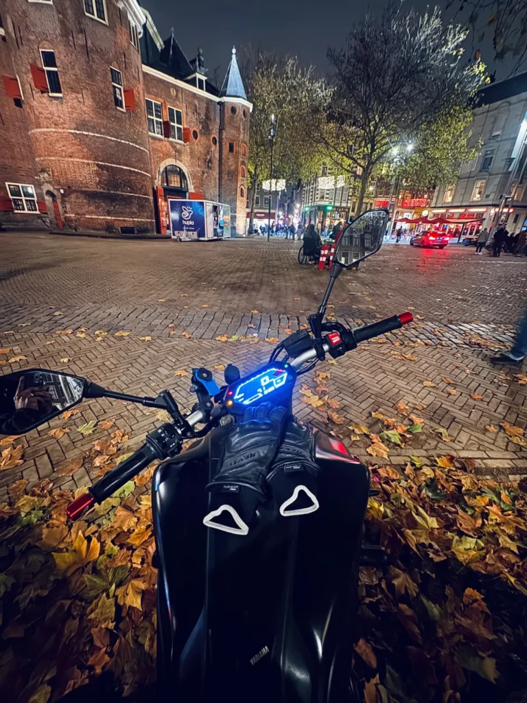 Rider POV on a Yamaha MT-07 at night in Amsterdam with city traffic ahead