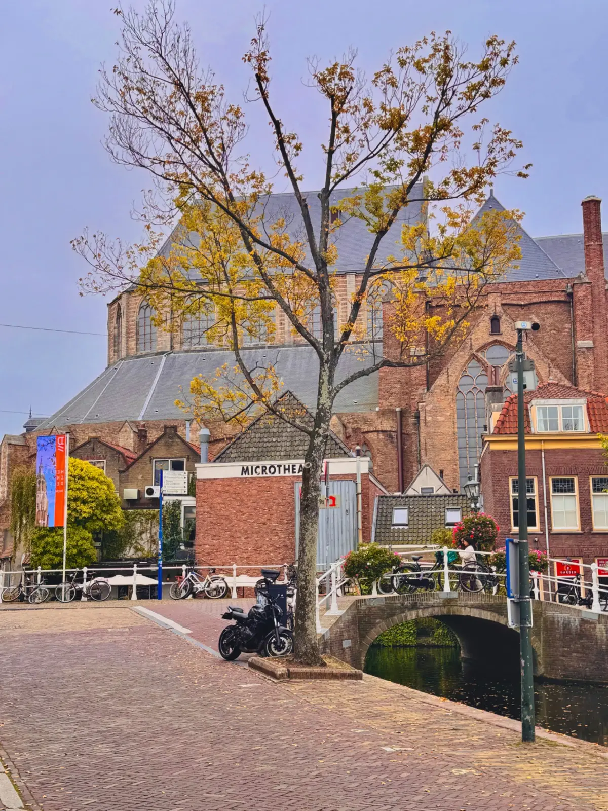 Black Yamaha MT-07 parked near a historic church and canal bridge