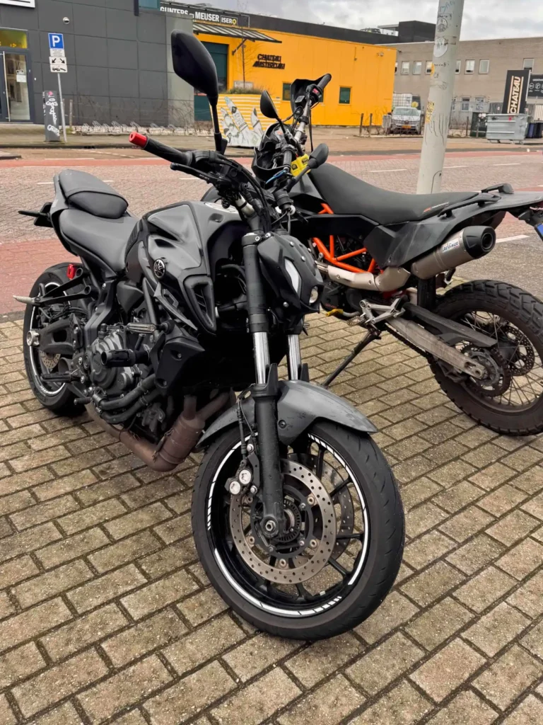 Yamaha MT-07 and adventure motorcycle parked together during city group riding