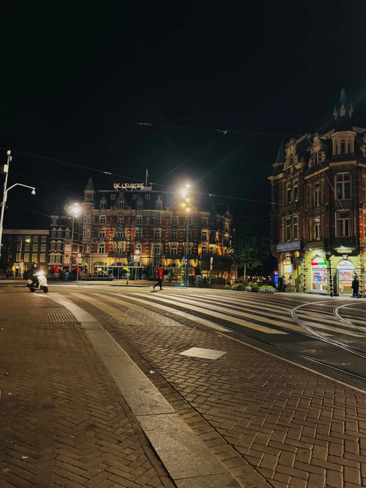 Night city intersection with tram tracks and crosswalks for motorcycle cornering awareness