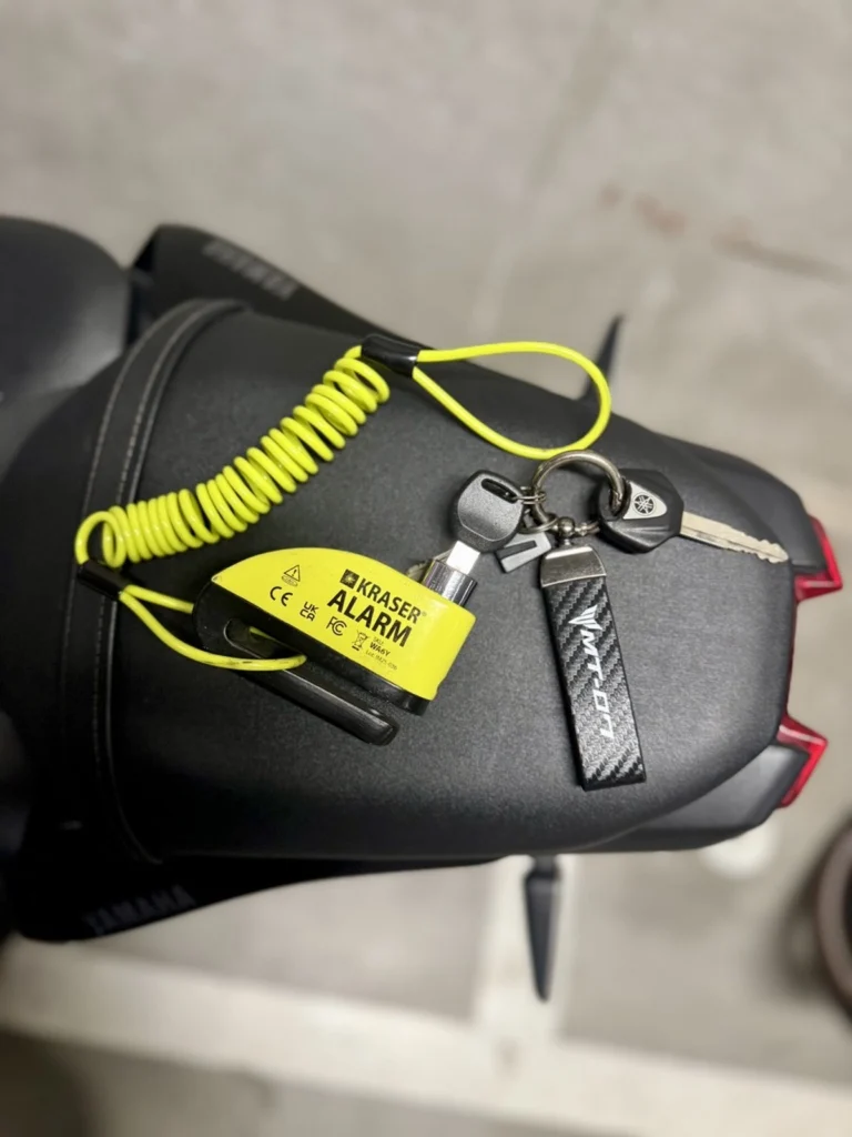 Kraser yellow alarm disc lock and motorcycle keys placed on a Yamaha MT-07 seat