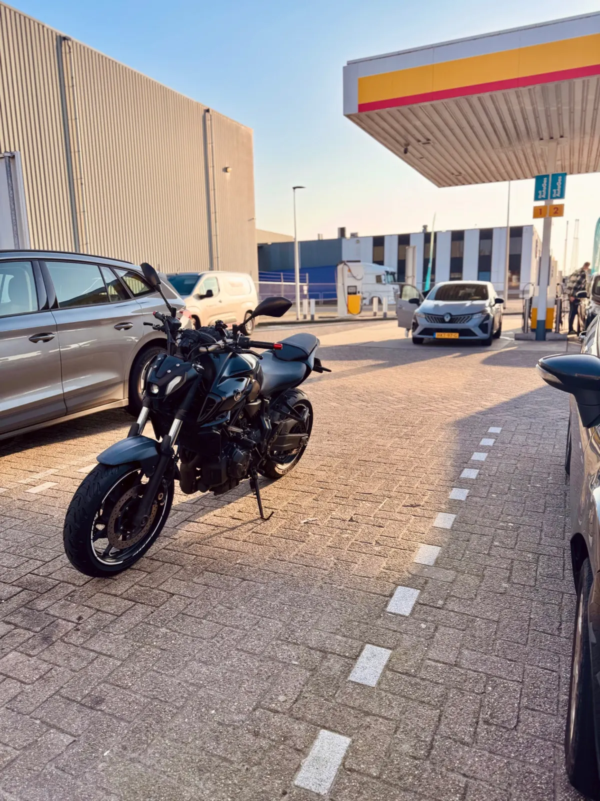 Yamaha MT-07 parked at a fuel station, useful for lane positioning and traffic awareness