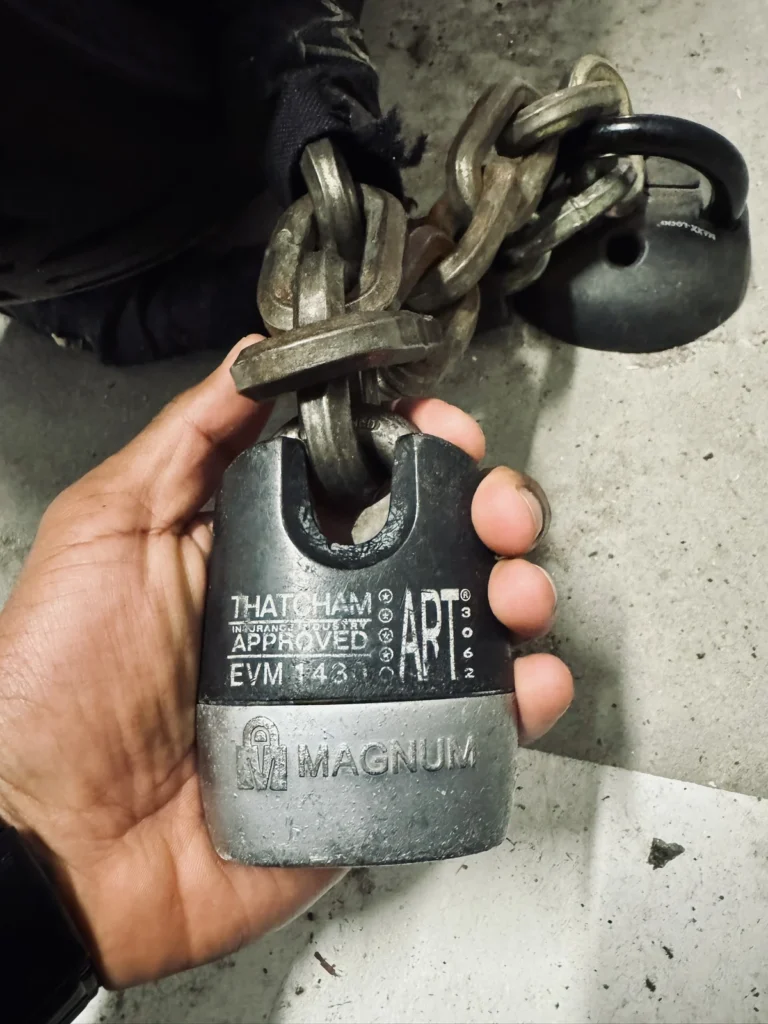 Heavy motorcycle chain lock secured near the rear wheel of a Yamaha MT-07