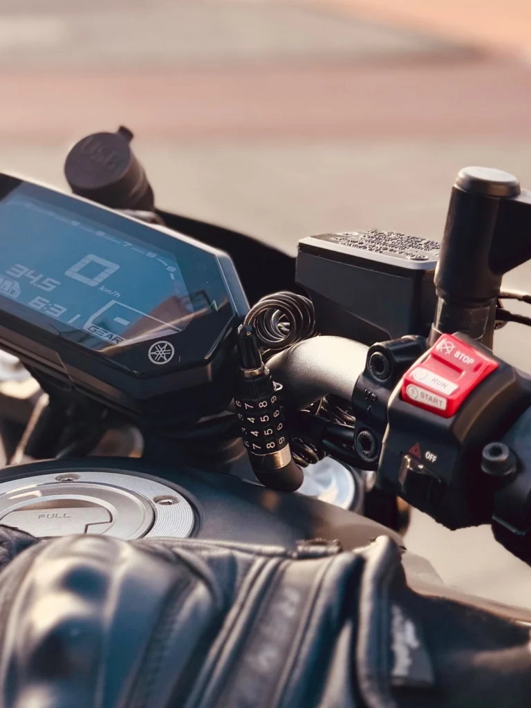 Combination cable lock attached near the Yamaha MT-07 handlebar and dashboard