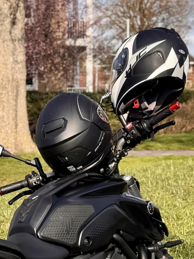 Two motorcycle helmets secured to a Yamaha MT-07 using a combination cable lock