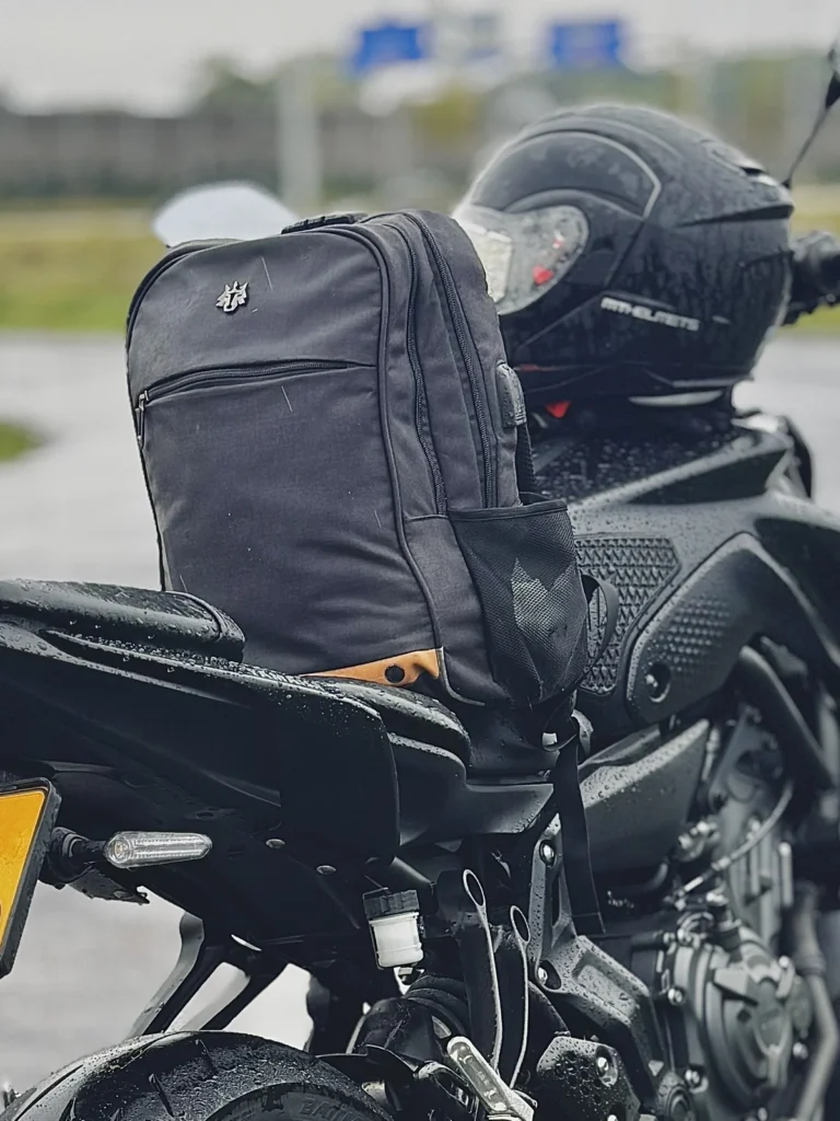 Everyday riding backpack placed on a Yamaha MT-07 motorcycle in rainy weather