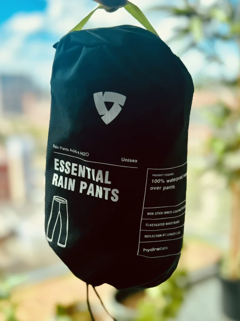 REV’IT Acid H2O essential rain pants packed in a black storage bag