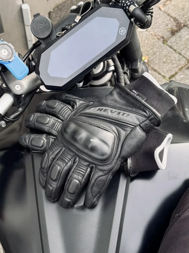 Abrasion resistant motorcycle gloves with knuckle protectors placed on a Yamaha MT-07 tank