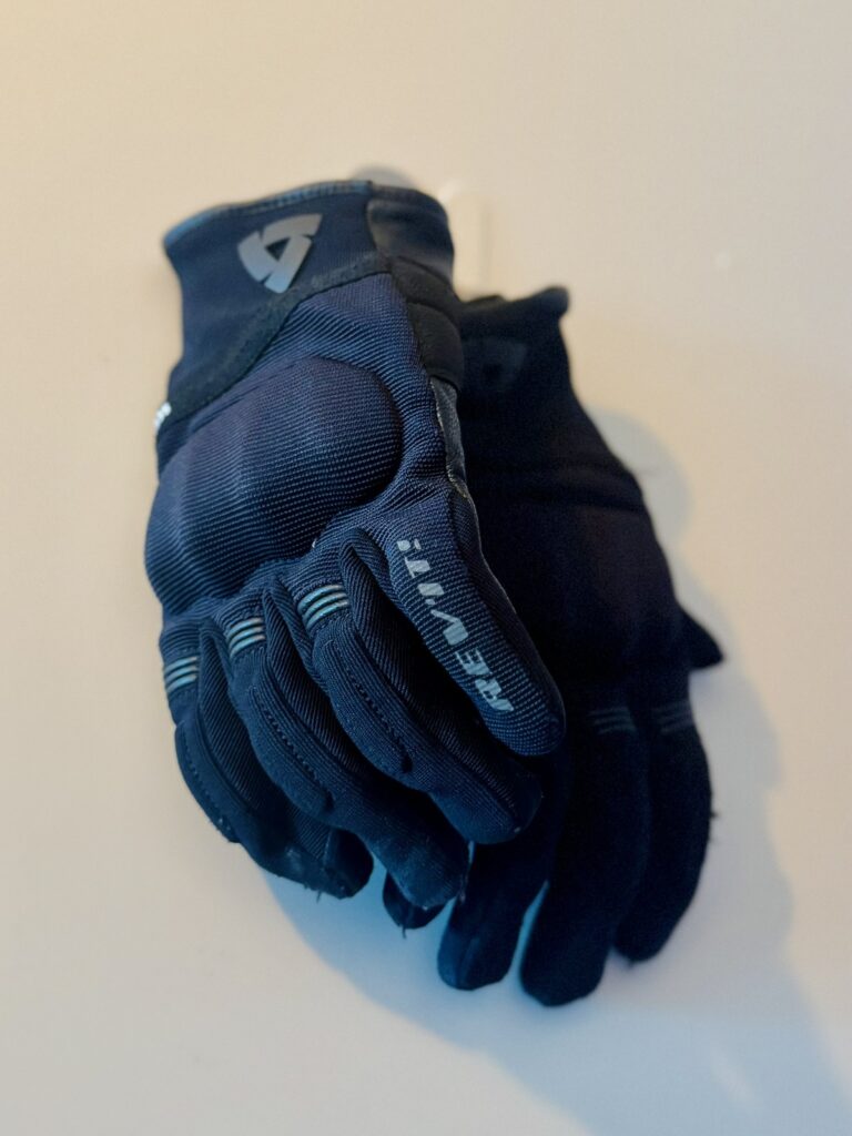 Pair of REV’IT Mosca 2 H2O motorcycle gloves placed on a light background