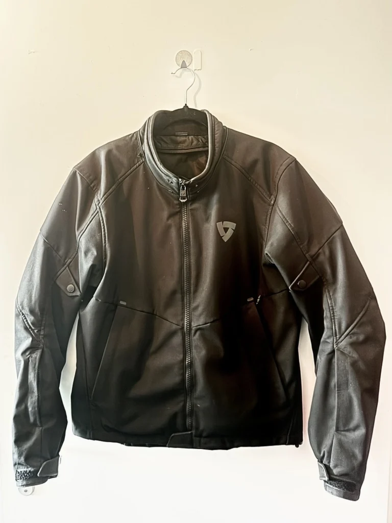 REV’IT Shade 2 H2O black motorcycle riding jacket hanging on a wall
