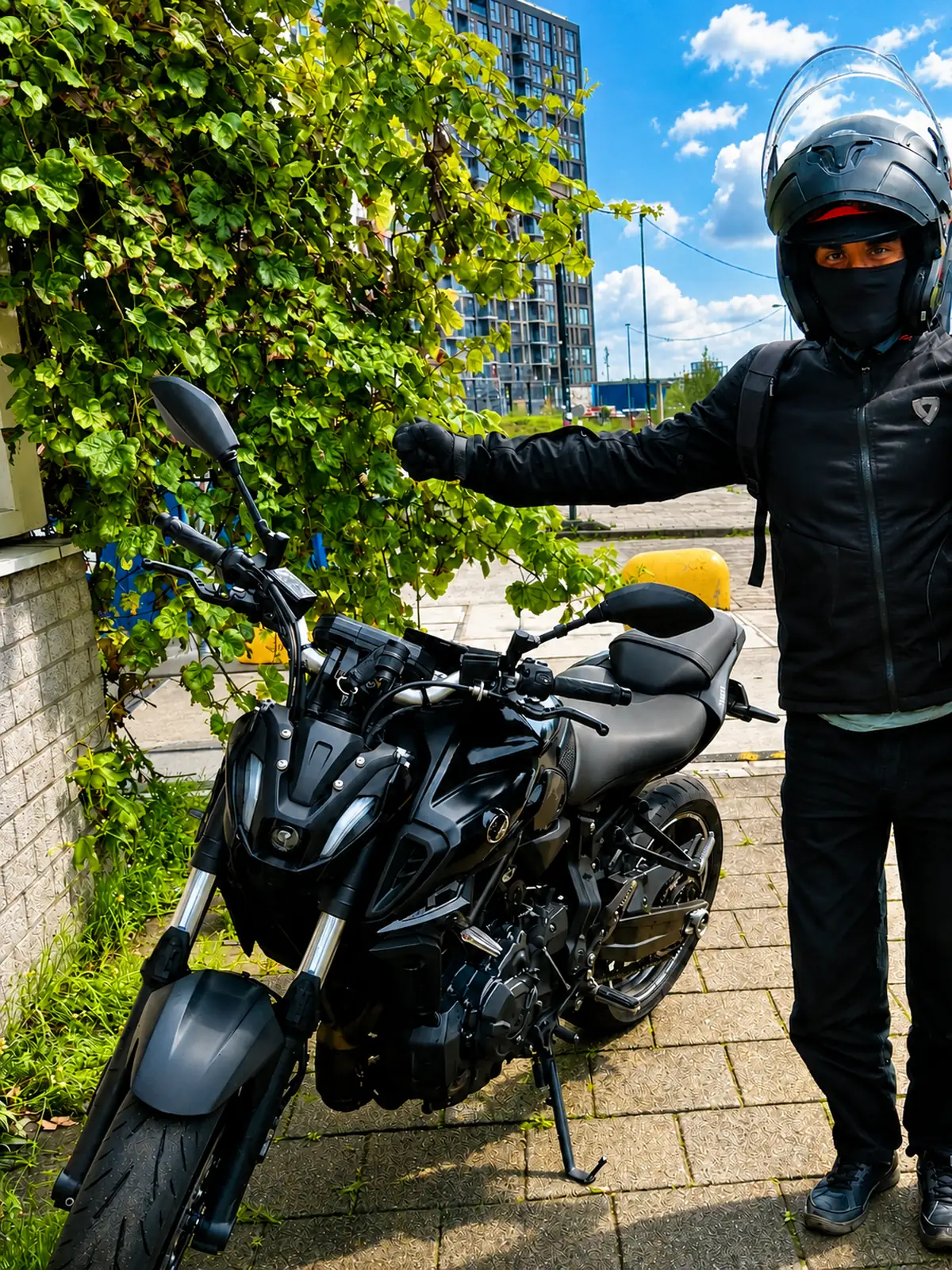 Rider standing beside a black Yamaha MT-07 while wearing protective motorcycle gear