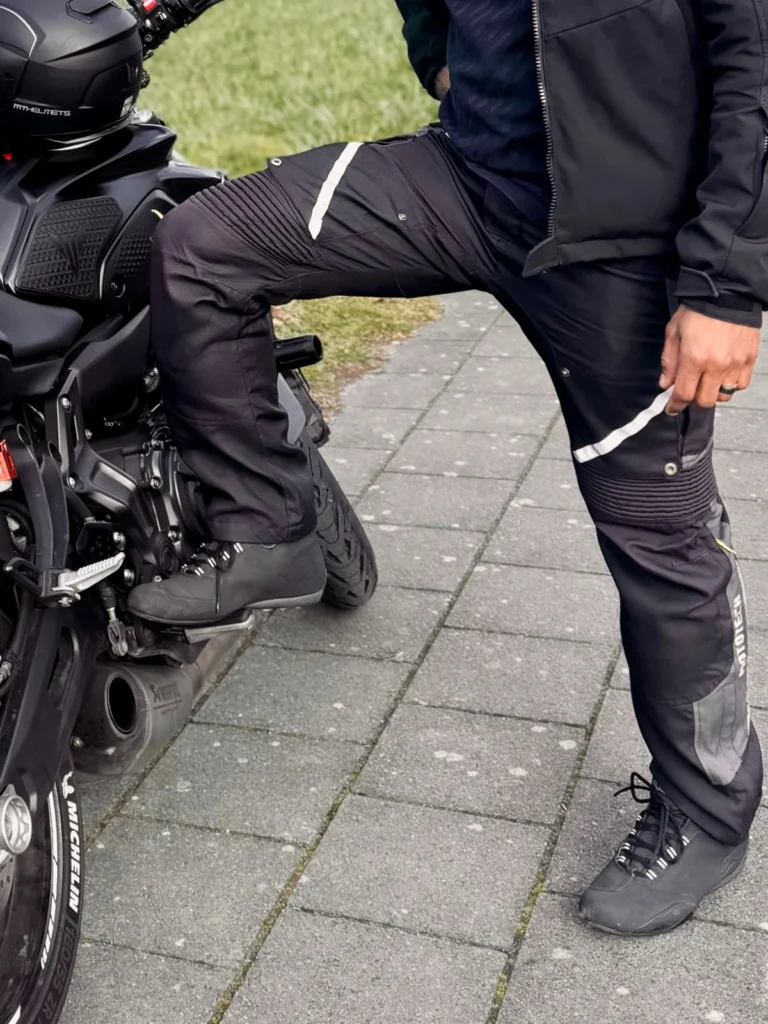 Rider wearing MotoTech motorcycle riding pants beside a Yamaha MT-07