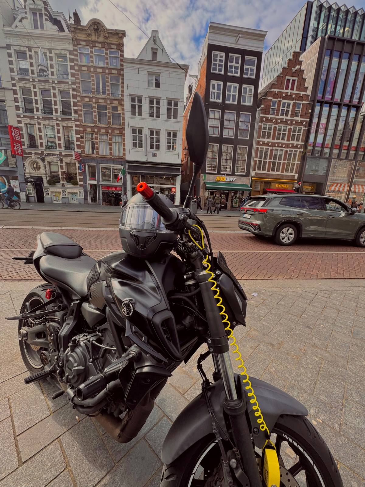 Close-up of Yamaha MT-07 parked on a busy city street with tram lines and traffic