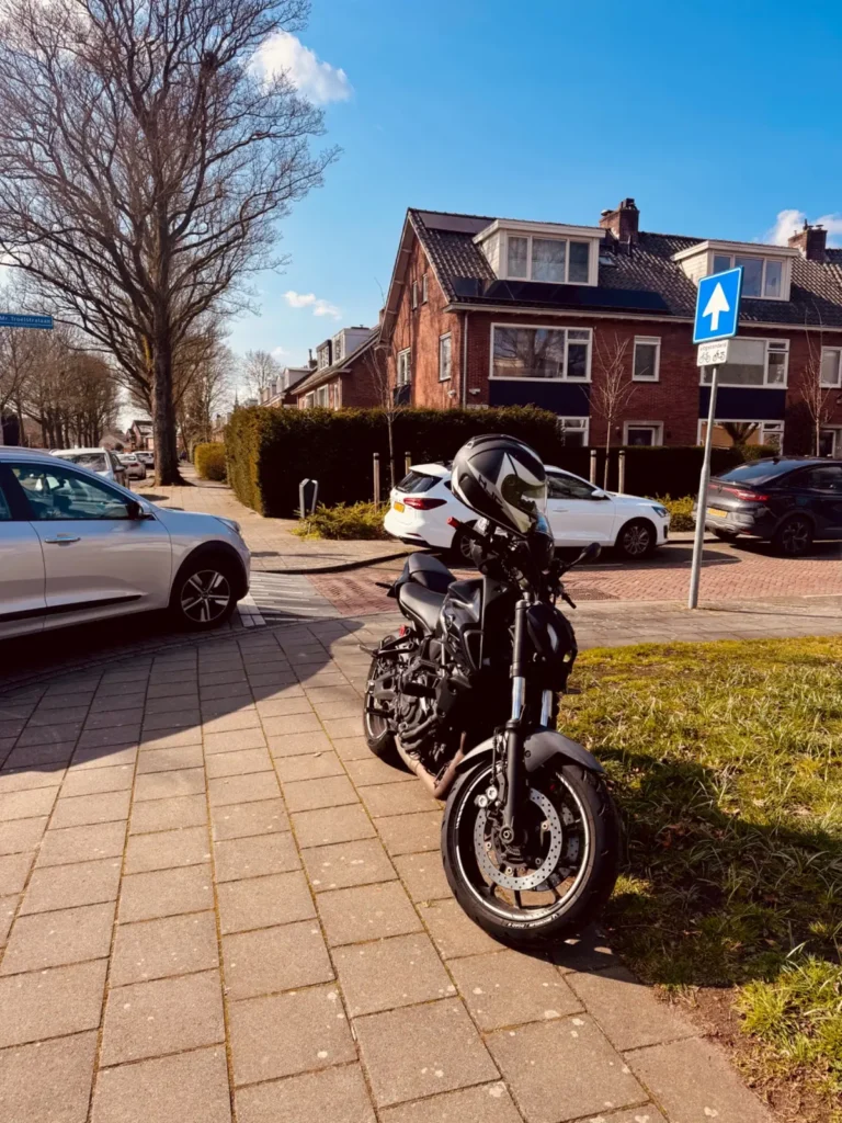 Yamaha MT-07 parked near a residential intersection with cars and a one-way sign