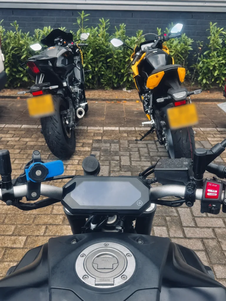 Rider POV from a Yamaha MT-07 showing nearby motorcycles and parking awareness