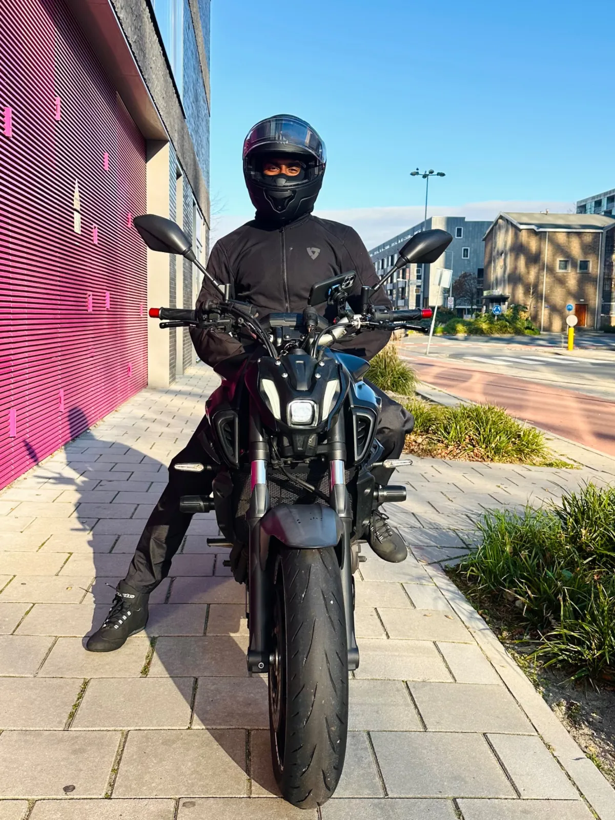 Rider sitting on a Yamaha MT-07 on a city sidewalk for bymrjohnson about page
