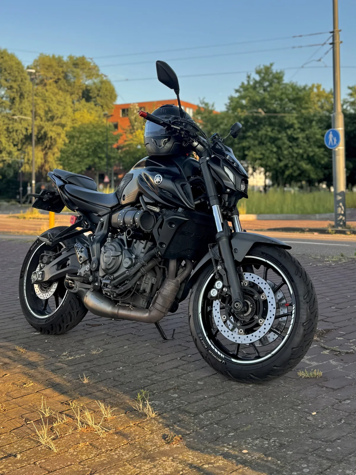 Black Yamaha MT-07 parked in warm evening light for the ByMrJohnson About page