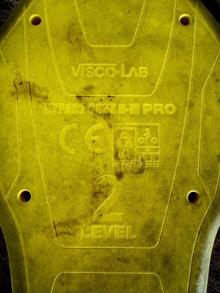 Close-up of a yellow Level 2 motorcycle back protector with CE rating markings