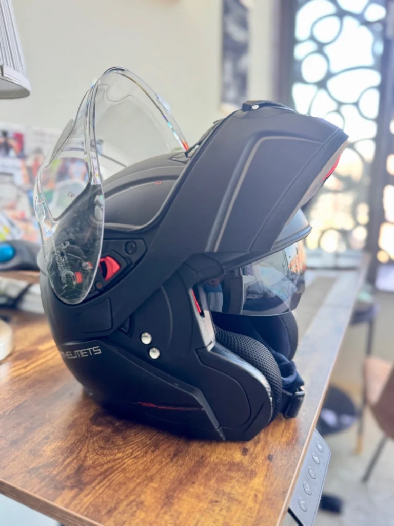 Modular motorcycle helmet with visor, chin bar and sun shade opened for reference