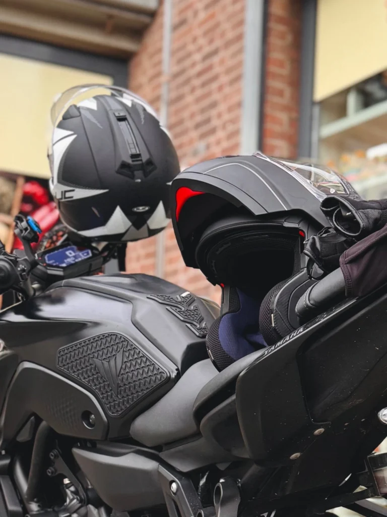 Two motorcycle helmets placed on a Yamaha MT-07 for size and style reference