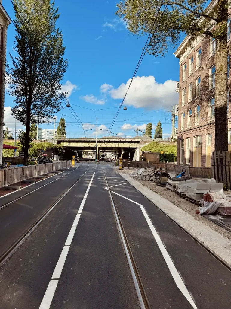 Urban road with tram tracks and roadworks gravel showing slippery lines and loose edges for motorcycle riders