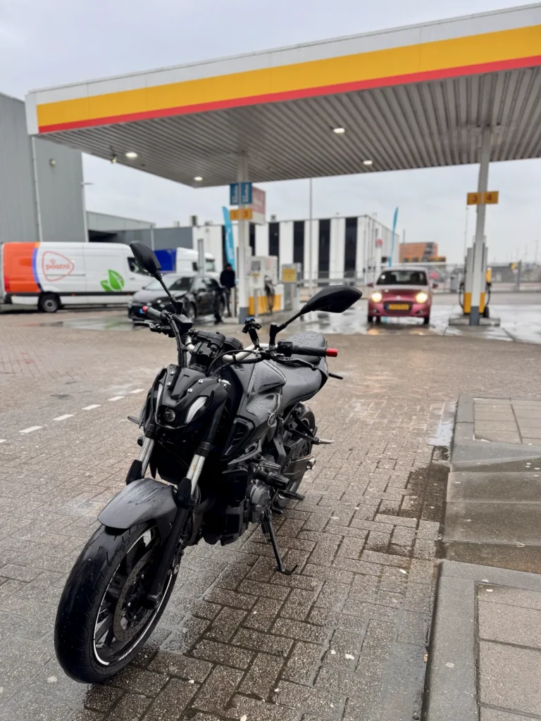 Yamaha MT-07 parked on wet fuel station pavement showing slippery road conditions