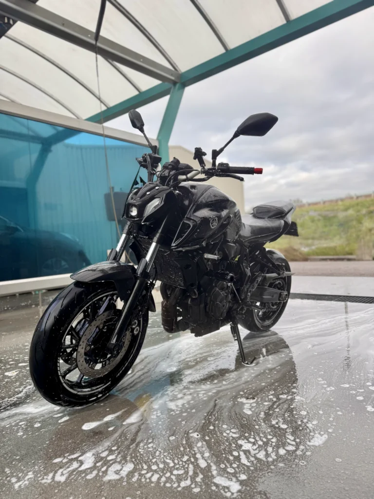 Yamaha MT-07 on a wet wash bay floor showing how slippery surfaces can reduce traction