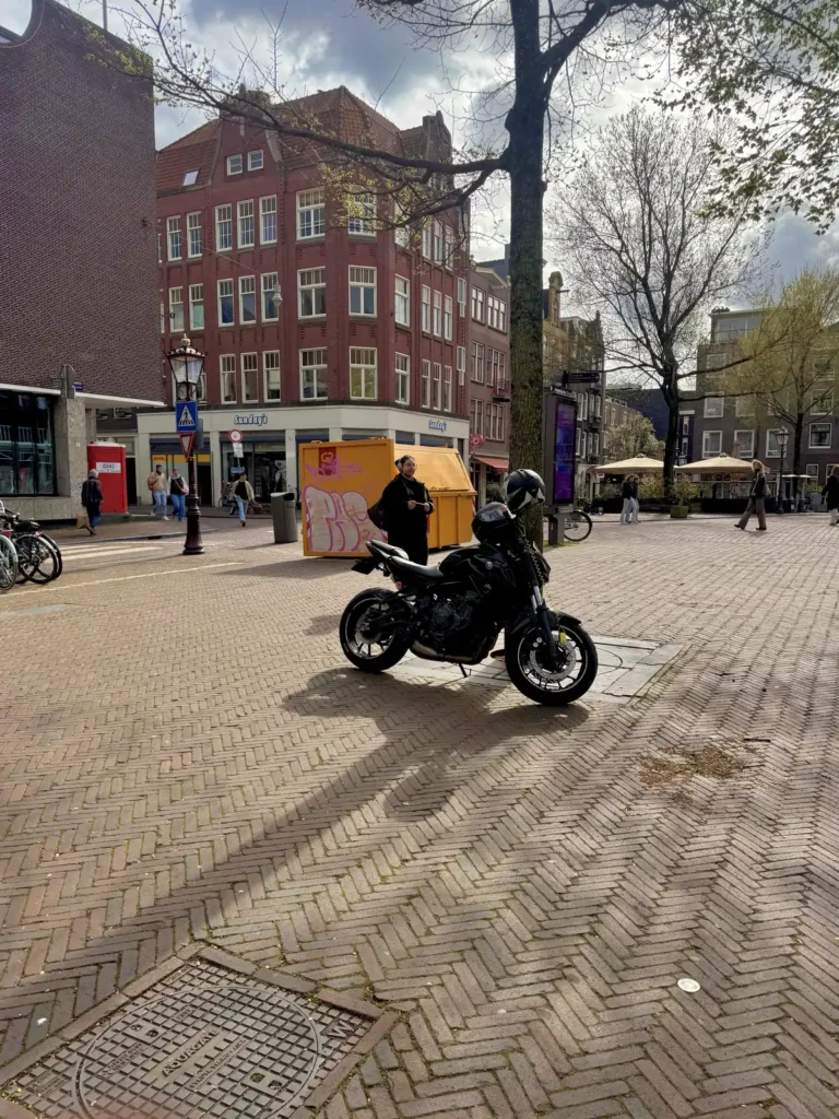 Motorcycle parked in urban streets with manholes