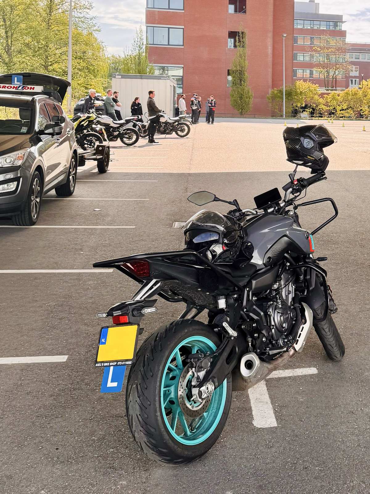 Parked motorcycle with a learner board sign at a safe practise area