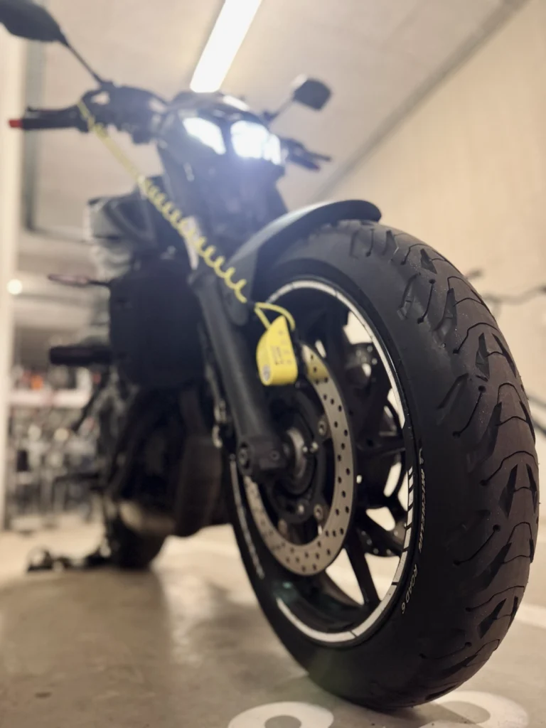 Motorcycle front tyre being checked before a wet-weather ride